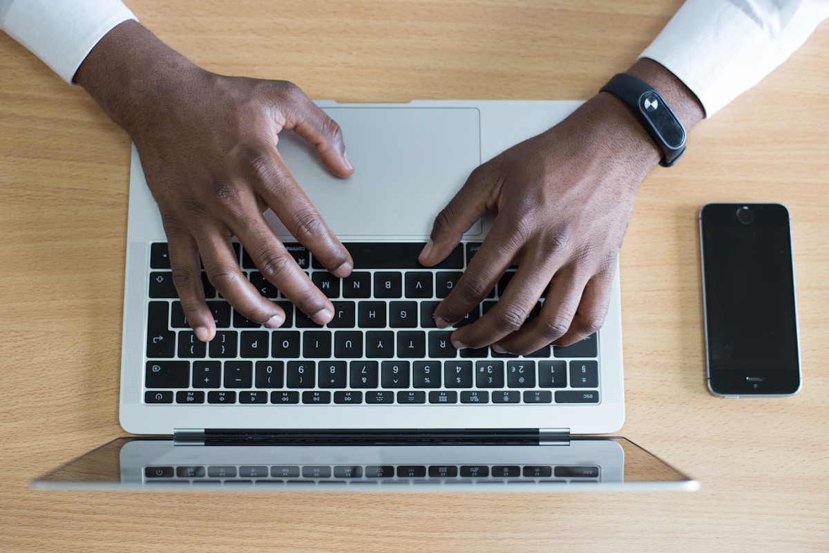 Dallas CPA reviewing tax preparation documents and a calculator with a client